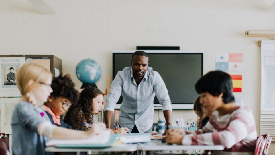 Teacher working with students in a classroom