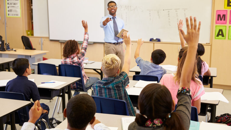 Students Raising Hands In Math Class