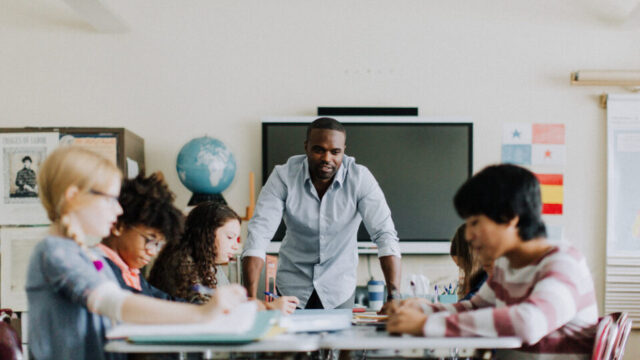 Teacher working with students in a classroom