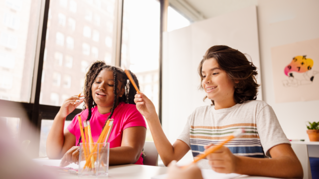 two middle school students are working on a math activity together