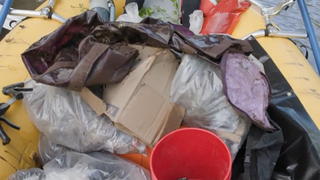 Trash collected from a river piled on a cleanup raft