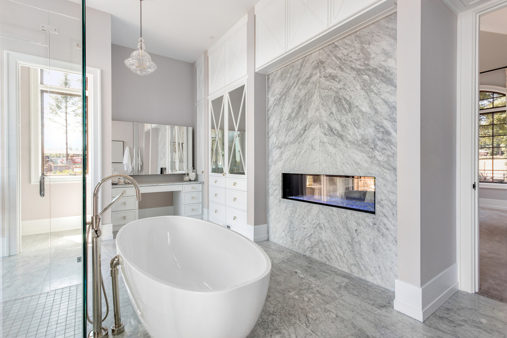 Master-bath- floating-tub-marble-raised-fireplace.jpg