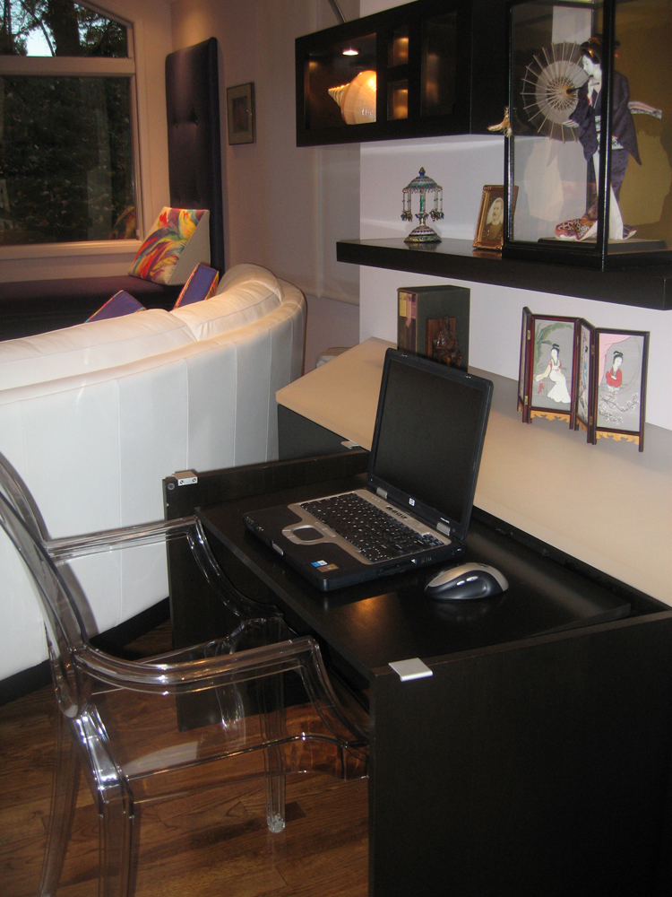 Home office hidden in family room cabinetry