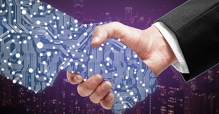 IT Career Paths_697.5x364.44 IT professional shaking hands with a business man when offered a job