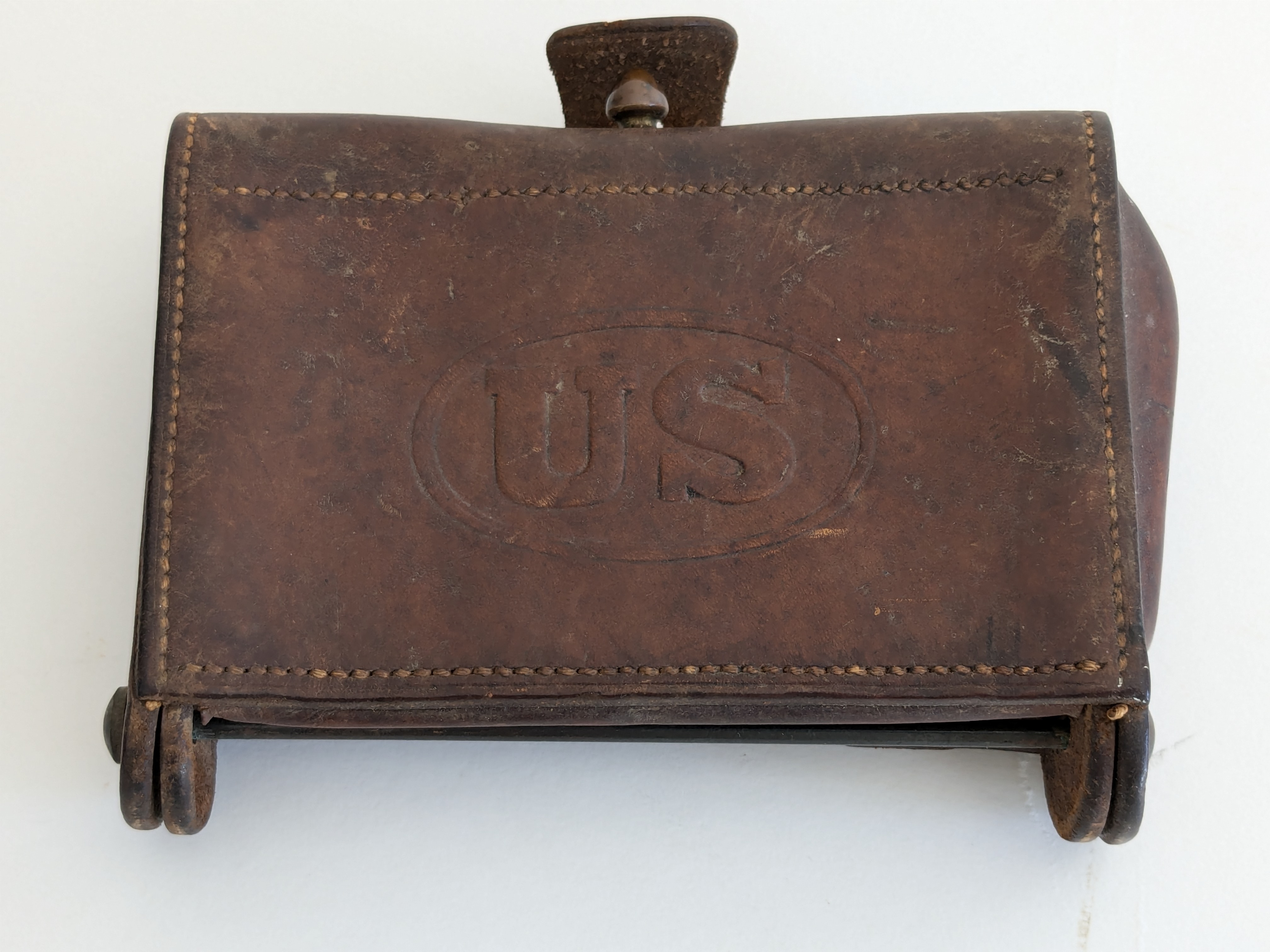Front of a brown leather McKeever cartridge box with US in an oval on the flap