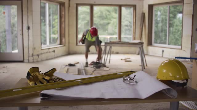 Focus on items in foreground with construction worker in background