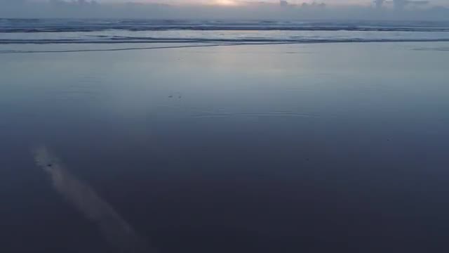 Beautiful sunset beach reflections contrail
