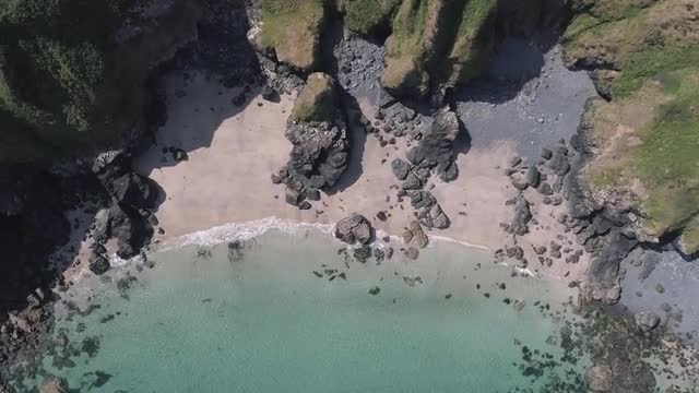 Beautiful cliffs and see through water aerial title sequence in Cornwall, England, United Kingdom