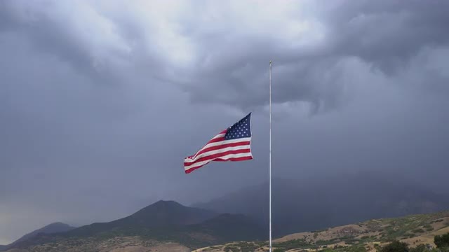 American Flag at half mast blowing in the wind