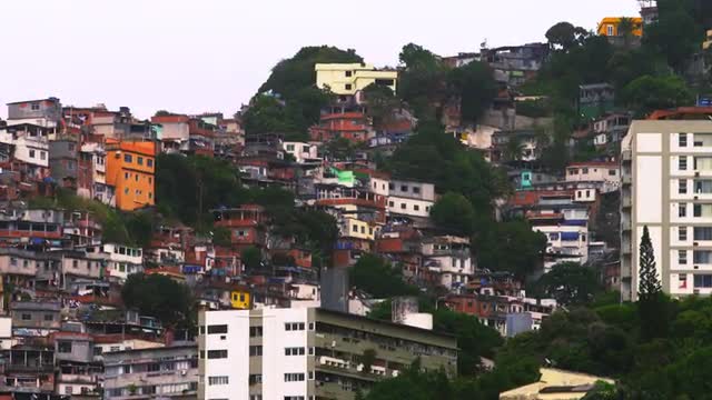 Panning shot of houses at a favela along the mountainside in Rio de Janeiro, Brazil