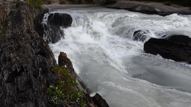 Slow Motion Water flowing into hole at the Natural Bridge in Yoho Park.