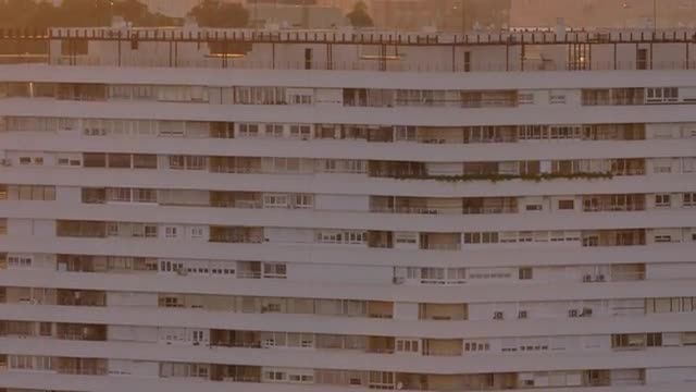 Apartment block exterior and mountain at sunset in Alicante, Spain