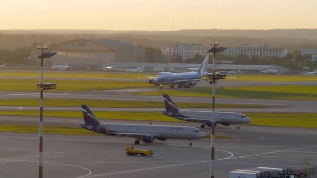 Driving planes in Sheremetyevo Airport at sunset, Moscow