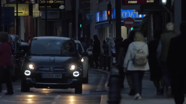 Car and people traffic in night street, Spain