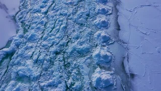 Aerial shot from the frozen lake to downtown Chicago