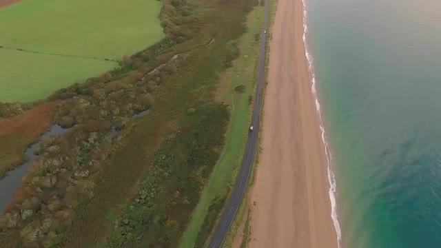 Drone follows car on ocean highway