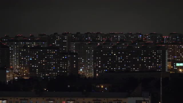 Night city illuminated with lights in apartment blocks. Moscow, Russia