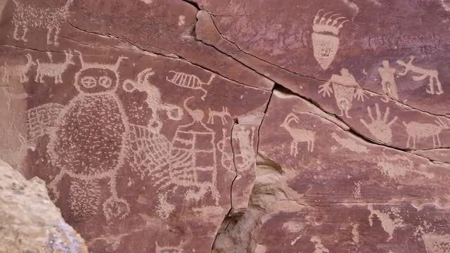 Panning across big petroglyph panel with bear paw