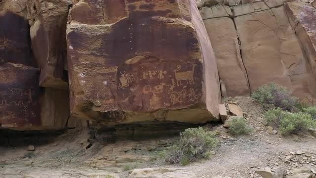 Rotating around rock with petroglyphs on the edge of them