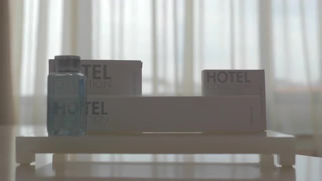 A close up of several cosmetics items being put on a table