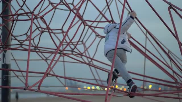 Active child on climbing net