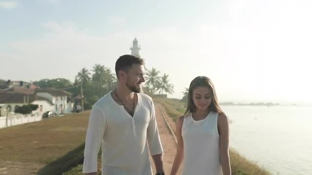 Couple Enjoying Walk On Beach