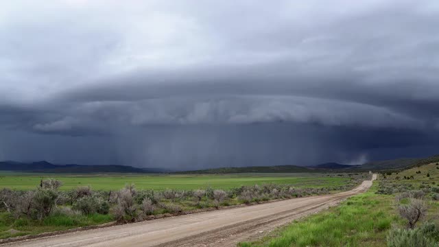 Time lapse of shelf cloud super cell storm moving over landscape