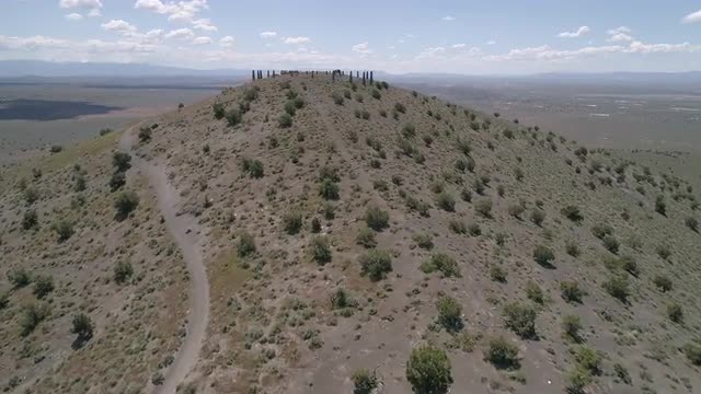 Flying along ridge at Pahvant Butte towards cement pillars on hill top