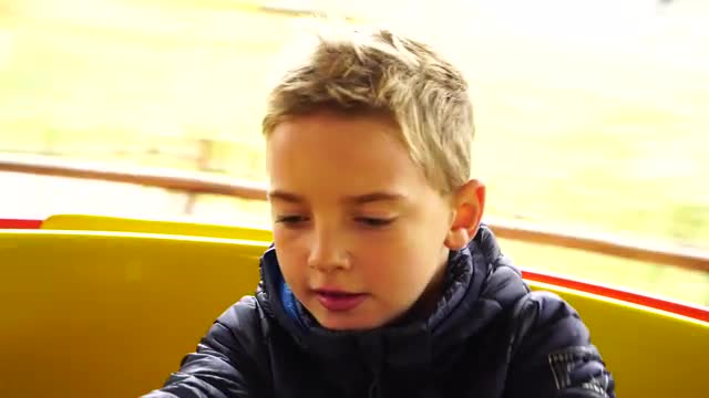 boy riding in carousel
