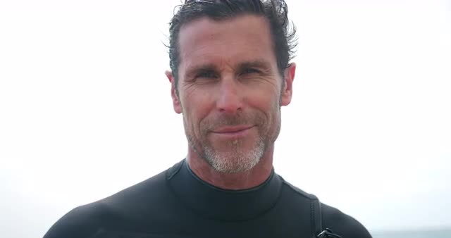 Man standing with surfboard
