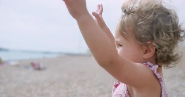Little girl raising arms