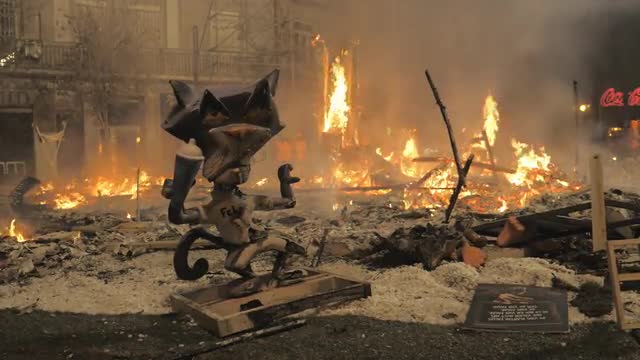 Cat Felix ninot and fire on La Crema during Fallas, Spain