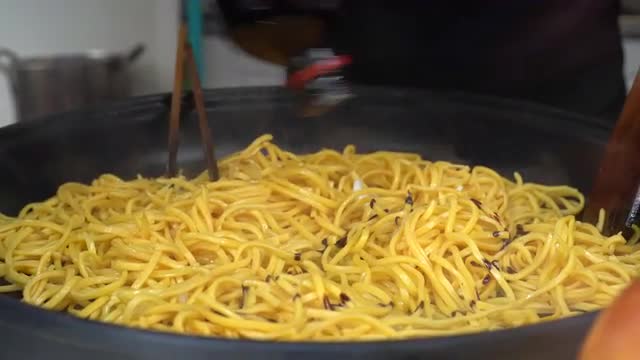 Vendor preparing noodles
