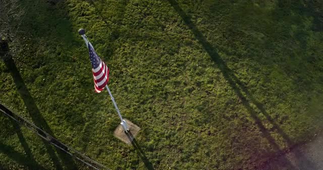 Aerial shot of american flag waving in wind