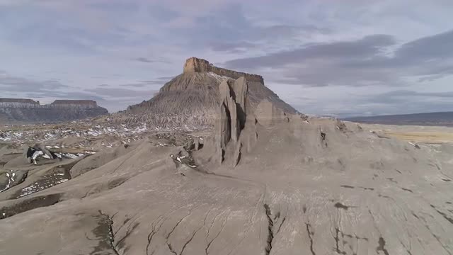 Flying over eroded desert terrain towards Factory Butte