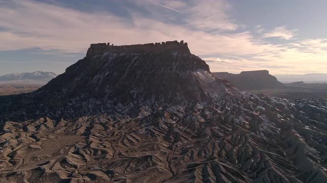 Flying through rugged desert terrain towards Factory Butte