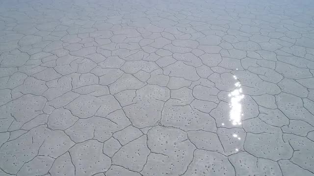 Sun sparkling in the water over the Bonneville Salt Flats in winter