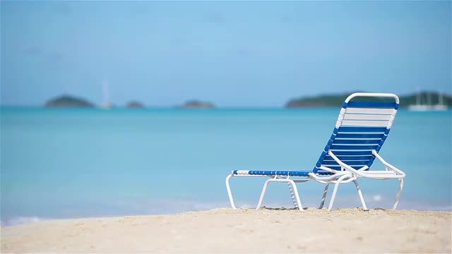 One sunbed on white tropical caribbean beach