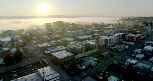 Wide aerial shot of sunrise over non-descript city