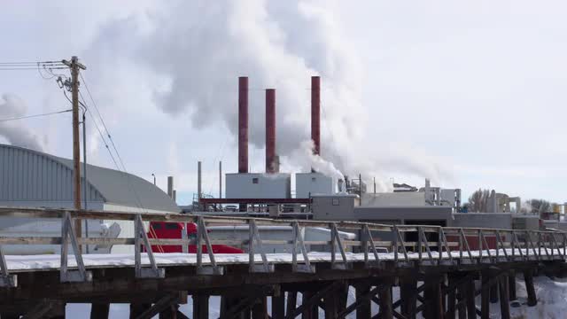 Steam rising from factory smoke stacks