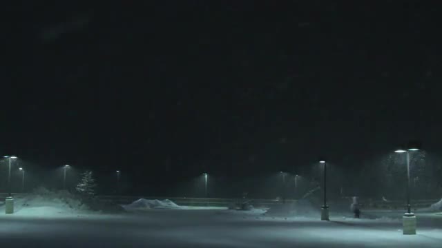 Skier is Towed Across a Parking Lot