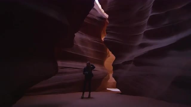 Woman walking through desert canyon