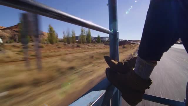 Tight shot of a woman's feet while riding in the back of a pick up truck