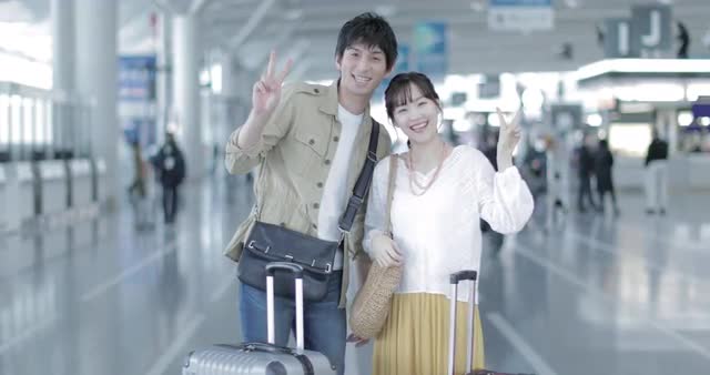 Young attractive and happy Japanese couple at the airport