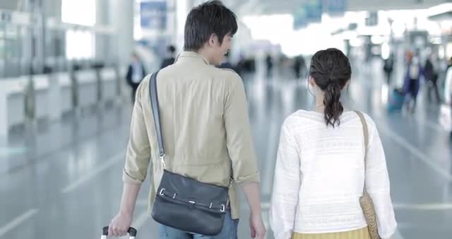 Young attractive and happy Japanese couple at the airport