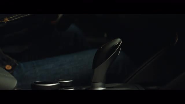 Push in shot of a person shifting an Alfa Romero 