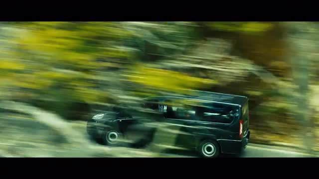Tracking Shot of a Van Driving Down the Road