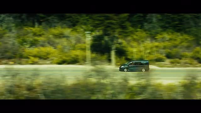 Tracking Shot of a Van Driving Down the Road