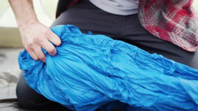 Man Pulling Sleeping Bag Out of Compression Sack