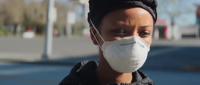 Attractive girl in mask alone in city